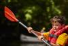 Cub Scout paddling a kayak