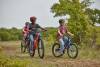 Cub Scouts riding bicycles in the park