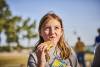 Cub Scouts at the lake - girl eating a s&#039;more